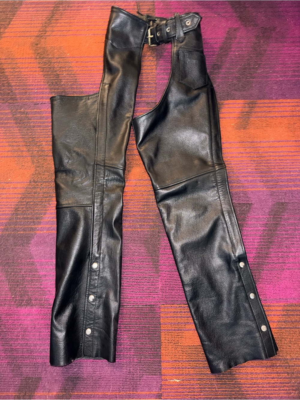 Black Leather Motorcycle Chaps with a Pocket and Snap Details. Adjustable